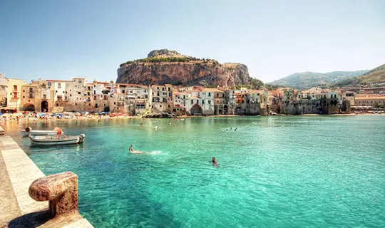 SImmers and boats in crystal clear sea