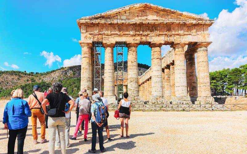 Sicily Guide Tourists visiting Doric temple in Segesta